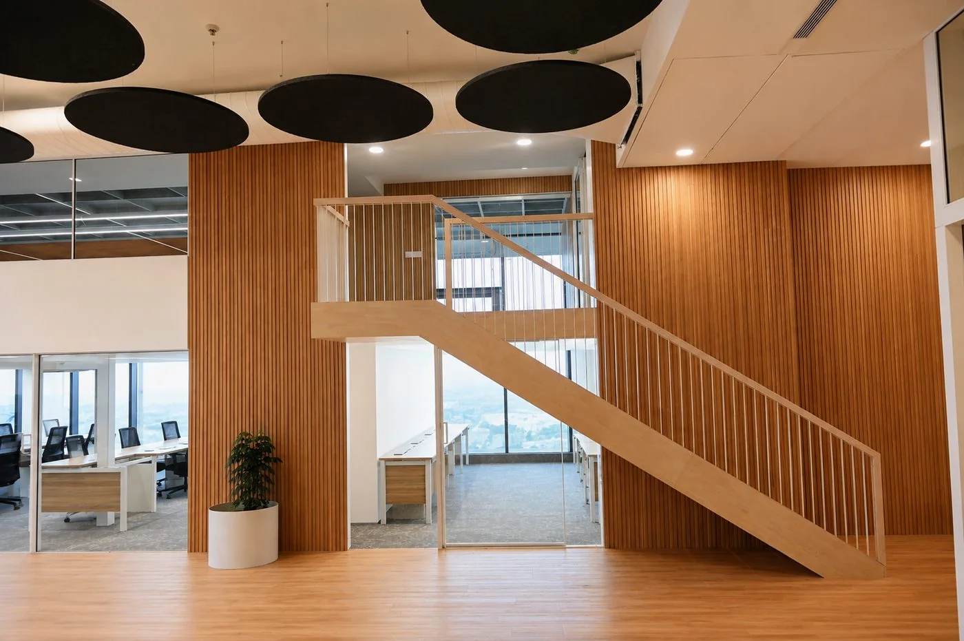 OP Tower interior workplace with timber feature staircase, acoustic ceiling and glass-walled offices